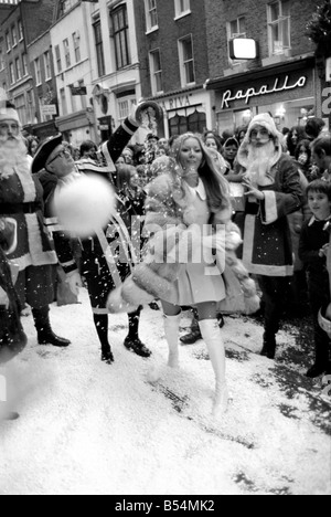 Festive Scenes. In South Molton street, Mayfair, it was snowing but it was only plastic snow that was falling. Singer Clodagh Rogers was present with Father and Mother Christmas, to open the street's Christmas display of lights. Clodagh Rogers throws a snowball. December 1969 Z11515-002 Stock Photo