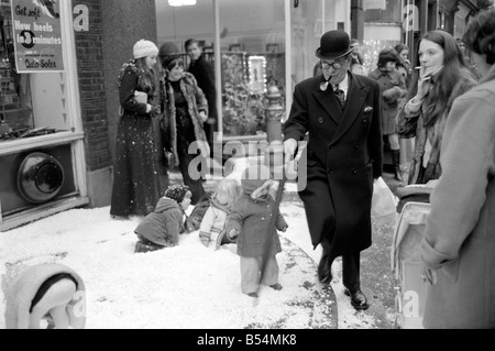 Festive Scenes. In South Molton street, Mayfair , it was snowing but it was only plastic snow that was falling. Singer Clodagh Rogers was present with Father and Mother Christmas, to open the street's Christmas display of lights. Man walks through Plastic snow. December 1969 Z11515-004 Stock Photo