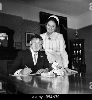 Arsenal centre half and Capt. of Northern Ireland world cup team Terry Neill had his hand full yesterday (Tues). His parcel was Stock Photo