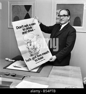 Politics. Fred Mulley Minister of Transport outlined his plans for a Christmas safety drive to Sunday Mirror motoring correspondent Roy Spicer this afternoon. Amongst the literature was a large poster and a driving manual which Mr. Mulley suggested (the manual) would be an ideal Christmas present for every driver. December 1969 Z11580-001 Stock Photo