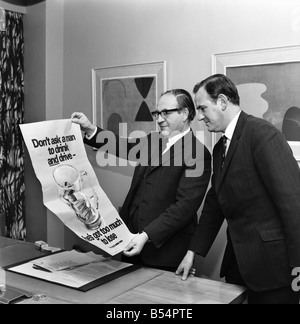 Politics. Fred Mulley Minister of Transport outlined his plans for a Christmas safety drive to Sunday Mirror motoring correspondent Roy Spicer this afternoon. Amongst the literature was a large poster and a driving manual which Mr. Mulley suggested (the manual) would be an ideal Christmas present for every driver. December 1969 Z11580-003 Stock Photo