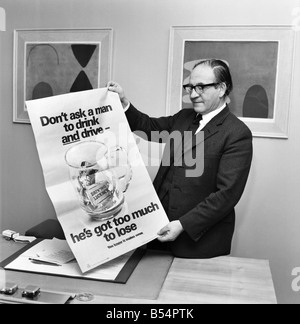 Politics. Fred Mulley Minister of Transport outlined his plans for a Christmas safety drive to Sunday Mirror motoring correspondent Roy Spicer this afternoon. Amongst the literature was a large poster and a driving manual which Mr. Mulley suggested (the manual) would be an ideal Christmas present for every driver. December 1969 Z11580-006 Stock Photo