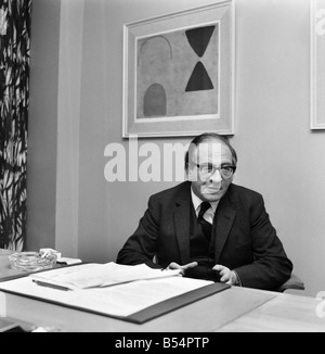 Politics. Fred Mulley Minister of Transport outlined his plans for a Christmas safety drive to Sunday Mirror motoring correspondent Roy Spicer this afternoon. Amongst the literature was a large poster and a driving manual which Mr. Mulley suggested (the manual) would be an ideal Christmas present for every driver. December 1969 Z11580-007 Stock Photo