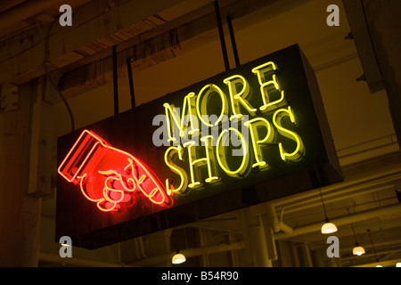 Neon sign hand pointing to More Shops downstairs at Pike Place Market in downtown Seattle, Washington Stock Photo
