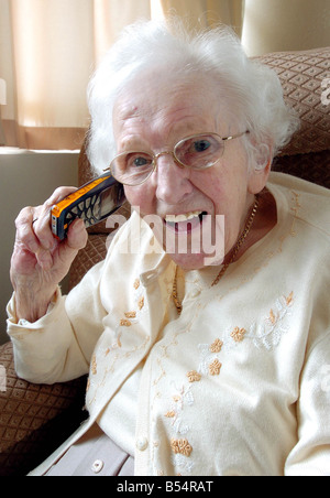 102 Year old Mary Milligan September 2007 with her trusty mobile phone at home in Shotts Lanarkshire Britain s oldest mobile phone fanatic Stock Photo