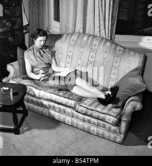 Women: Tall: Mrs. Helen Gavin President of The Tall Women's Association seen here around the house and kitchen. September 1953 Stock Photo