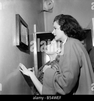 An unusual role for Margaret Lockwood is taking a back-stage seat. She chaperones her daughter Julia who gives a wonderful performance as Heidi in the television program. She is word-perfect and the talented daughter of Margaret is following in mother's footsteps. Margaret watches over her as she attends the studio. During rehearsals she never interferes will her daughter's TV program. The way Julia acts with complete disregard for the cameras coolly and confidently completely surprised her mother. She said 'I never knew she could do it'. November 1953 D6677-oo7 Stock Photo