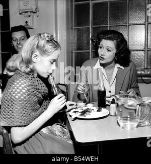 An unusual role for Margaret Lockwood is taking a back-stage seat. She chaperones her daughter Julia who gives a wonderful performance as Heidi in the television program. She is word-perfect and the talented daughter of Margaret is following in mother's footsteps. Margaret watches over her as she attends the studio. During rehearsals she never interferes will her daughter's TV program. The way Julia acts with complete disregard for the cameras coolly and confidently completely surprised her mother. She said 'I never knew she could do it'. November 1953 D6677-oo7 Stock Photo