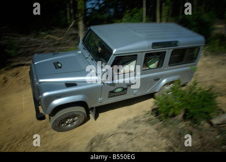 Off roading silver metallic Land Rover Defender 110 TD5 by Land Rover Experience used for driver training. Europe, UK, England. Stock Photo