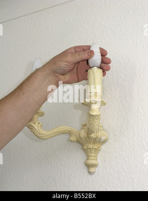 man fitting an energy efficient saving light bulb Stock Photo - Alamy
