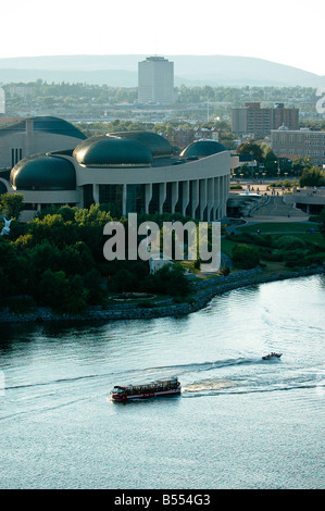 A tour and pleasure boats travelling infront of the Canadian Museum of Civilization in Hull, Quebec, Canada. Stock Photo