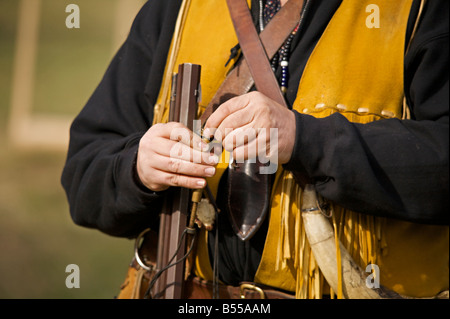 Man wearing trapper costume demonstrating black powder rifle at Steam Engine Show at Westwold, 'British Columbia', Canada Stock Photo