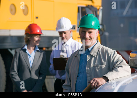 Three construction engineers together on survey Stock Photo
