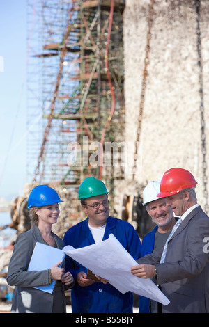 Four construction engineers studying plans Stock Photo