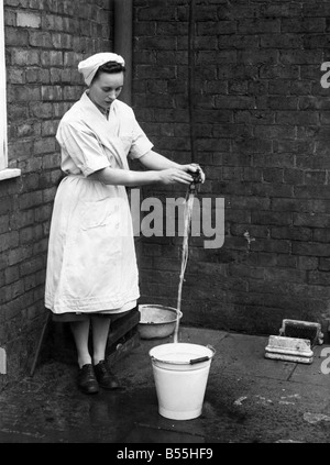 Glazebury water shortage. Some of the inhabitants are luckier than others. This being an example, as on the roof of this house has a large tank, and a hose pipe from it means a bucketful in a minute. October 1950 P012312 Stock Photo