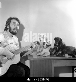 Salvatore Sangiorgi Italian singer and guitarist seen here at the RSPCA Home and Clinic Trenmare Gardens, London, singing to a pair of abandoned dogs December 1969 Z11924 Stock Photo