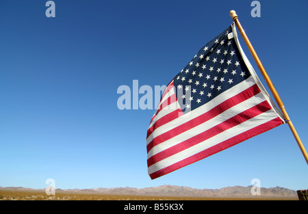 American flag by side of desert road near Twentynine Palms in California, United States of America. Stock Photo