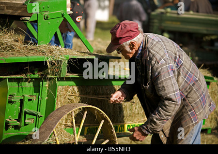 Hay bailing demonstration with a belt driven hay press during steam engine show, Westwold, 'British Columbia', Canada Stock Photo