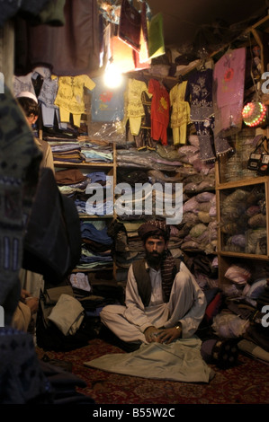 An Afghan man sits in his clothing store in the town of Gardez, Paktia province, Afghanistan, October 2004. Stock Photo