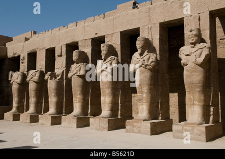 Statues of Ramses II as Osiris at the open courtyard in Temple of ...