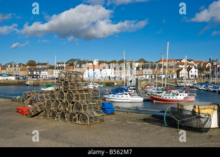 Anstruther harbour in Anstruther Fife Scotland with boats moored and fishing gear on pier Stock Photo