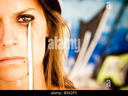 Dramatic scene with a knife in a woman face Stock Photo