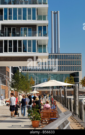 View along the Dalmannkaipromenade with pedestrians passing by at the new Hafencity at the enlarged port of Hamburg. Stock Photo