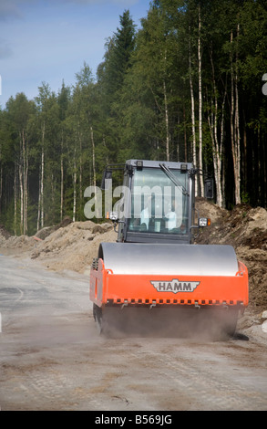 Hamm road roller compactor at road building site compacting the roadbed , Finland Stock Photo