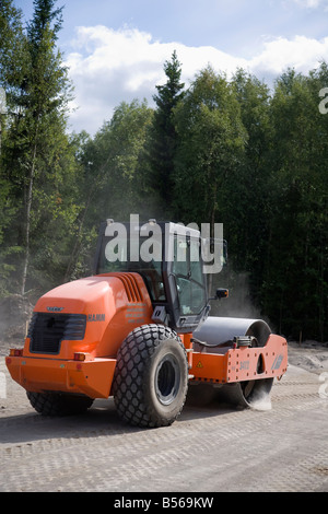 Hamm road roller compactor at road building site compacting the roadbed , Finland Stock Photo