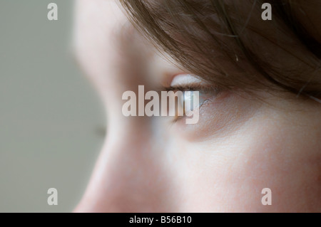 Female office worker gazing out of the window Stock Photo