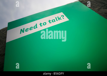 need to talk sign with phone number for psychological help for suicidal persons at the Cliffs of Moher, Ireland Stock Photo