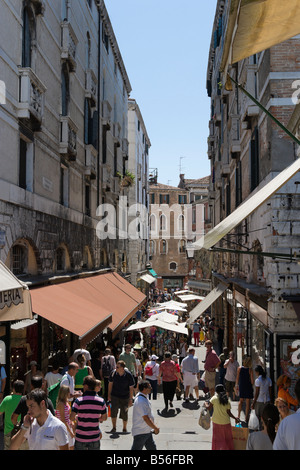 Shops leadiing off the Rialto Bridge, Salizada Pio X, San Marco, Venice, Veneto, Italy Stock Photo