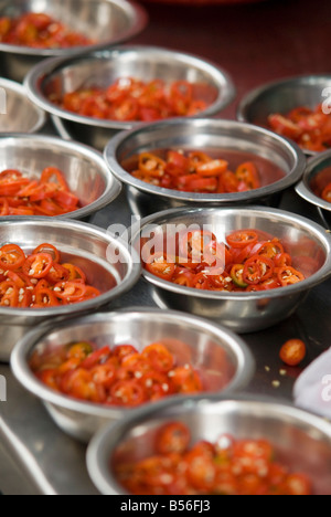 Small stainless steel bowls of chopped red chillies on a open restaurant counter in Chinatown, Kuala Lumpur, Malaysia Stock Photo