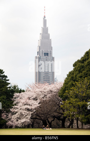 Cherry blossoms and the NTT DOCOMO Yoyogi Building, Shinjuku, Tokyo Stock Photo