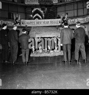 Instead of the customary Xmas tree in the centre of the prison wings of Strangeways Gaol, Manchester, there is to be a crib. A carol service will be held around the crib at which the prisoners will attend. Our picture shows, Prisoners at rehearsals and, decorating the prison and crib in the central hall. December 1969 Z12381-004 Stock Photo