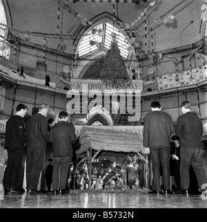 Instead of the customary Xmas tree in the centre of the prison wings of Strangeways Gaol, Manchester, there is to be a crib. A carol service will be held around the crib at which the prisoners will attend. Our picture shows, Prisoners at rehearsals and, decorating the prison and crib in the central hall. December 1969 Z12381-005 Stock Photo