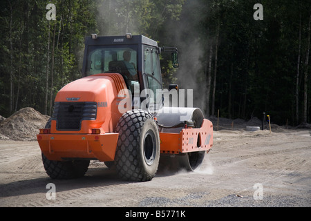 Hamm road roller compactor at road building site compacting the roadbed , Finland Stock Photo