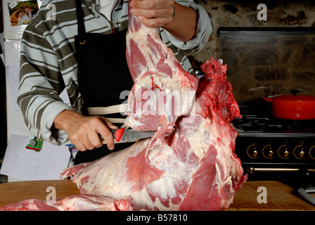 Stock photo of a man butchering a lamb Stock Photo