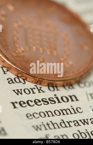 Recession economy money 1p penny coin alongside dictionary definition of recession Stock Photo