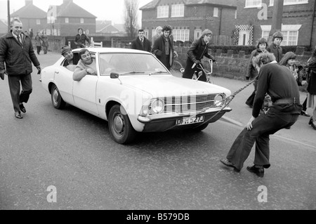 Strongman Reg Morris pulls car and passengers with his teeth. February 1975 75-00777-002 Stock Photo