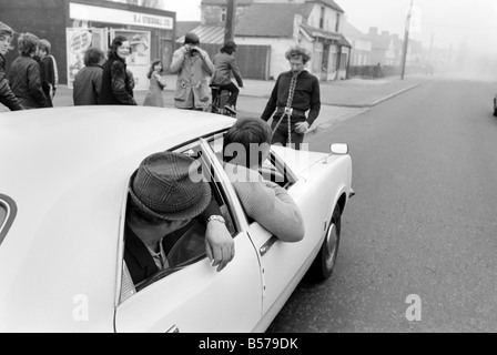 Strongman Reg Morris pulls car and passengers with his teeth. February 1975 75-00777-005 Stock Photo