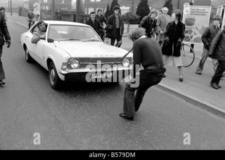 Strongman Reg Morris pulls car and passengers with his teeth. February 1975 75-00777-006 Stock Photo