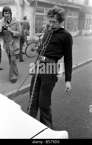 Strongman Reg Morris pulls car and passengers with his teeth. February 1975 75-00777-010 Stock Photo