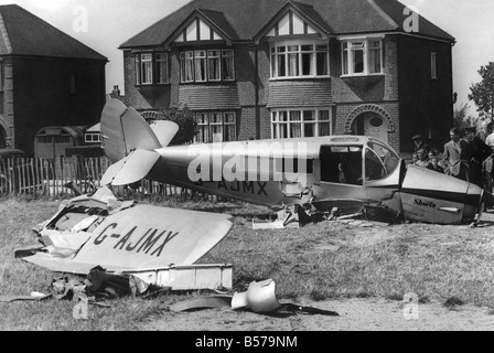 Air Accidents: Plane crash in Wallace Road, Rochester, Kent on Sunday, when an Auster Aircraft narrowly missed the rooftops of houses, struck a garden fence and crashed in a small clearing by the side of a church. July 1952 P004267 Stock Photo