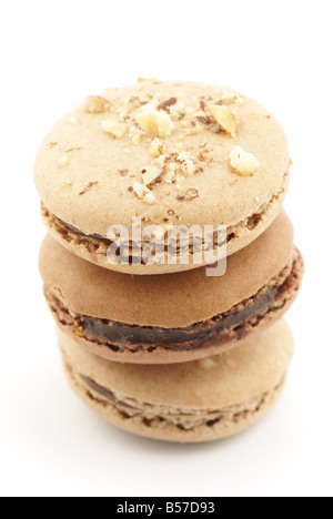 three chocolate and praliné nuts macaroons on a white background (cut-out) Stock Photo