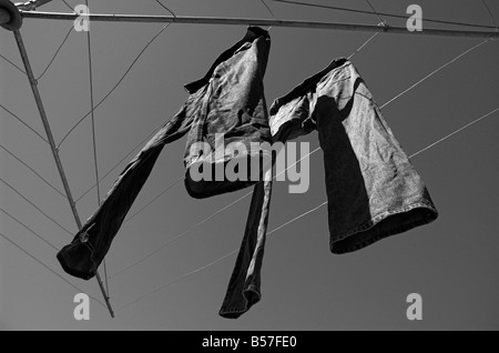 Denim jeans hanging on a Hills Hoist in an Australian backyard Stock Photo