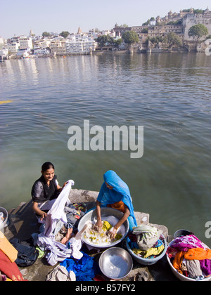 local women washing laundry and chatting life style in the lake Pichola in Udaipur, Rajasthan, India Stock Photo