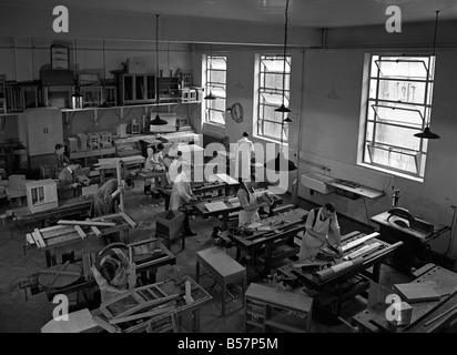 Adult men at a vocational woodwork and furniture making class at a school in Leicester, England, c. 1955 Stock Photo
