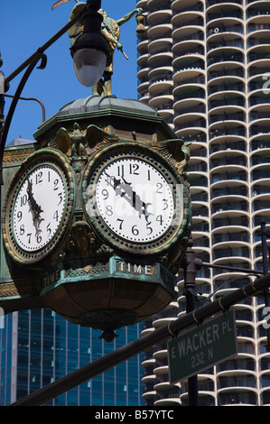 Old clock on the corner of 33 East Wacker Drive, Marina City in the background, Chicago, Illinois Stock Photo