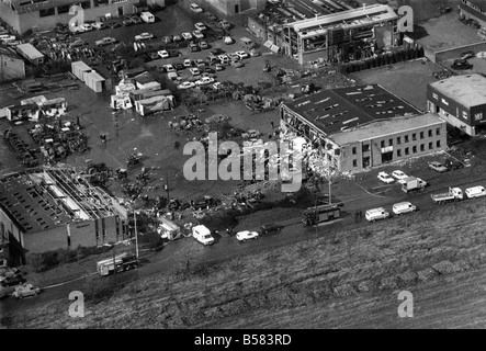 A fireman was killed and more than 80 people were injured yesterday when a van packed with explosives blew up in the middle of a busy industrial estate. Five factories were destroyed and dozens of other buildings damaged as the van went up 'like a thousand-pound bomb.' workers who had stooped to watch firemen tackle a blaze in the van were knocked off their feet. some had their clothes ripped off. window in offices and other buildings up to half a mile away were blown out by the explosion on the Fengate industrial estate at Peterborough, Cambs. March 1989 P004455 Stock Photo